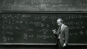 Gary Becker working at a chalkboard